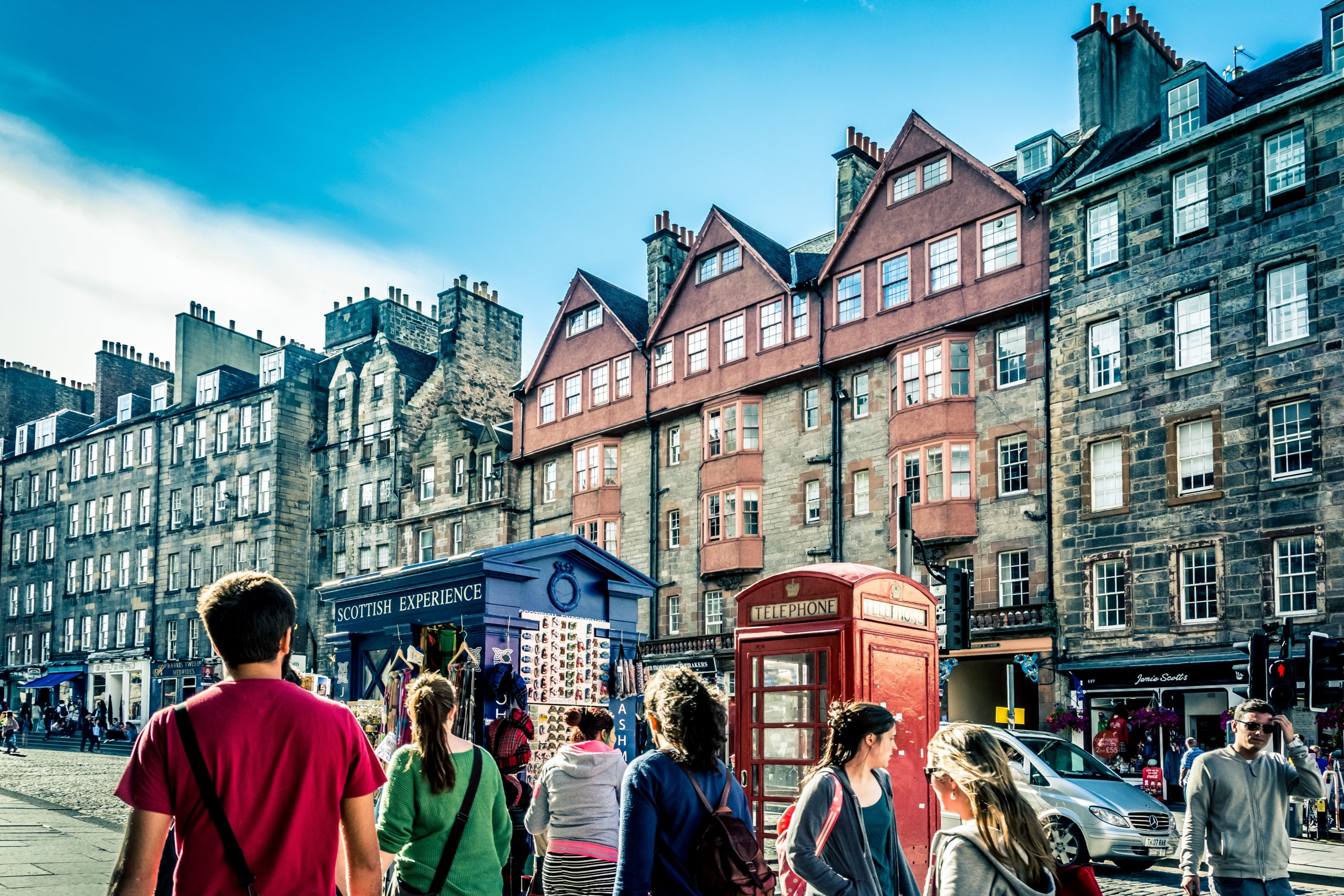 people walking beside telephone booth during daytime